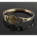 GEORGE V GOLD HALF SOVEREIGN BANGLE, 1912, the central coin set in yellow metal heart design bangle,