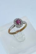 18CT GOLD & PLATINUM RUBY & DIAMOND CLUSTER RING, the single ruby (5 x 4mms) surrounded by twelve