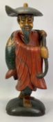 PAINTED WOODEN FIGURE - an oriental man carrying a large fish, 53cms H