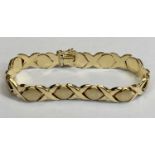 ITALIAN GOLD BRACELET STAMPED '14KT' - hollow core having textured semi ovals divided by lap over