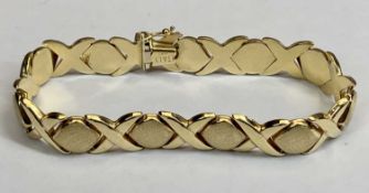 ITALIAN GOLD BRACELET STAMPED '14KT' - hollow core having textured semi ovals divided by lap over