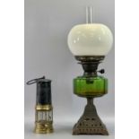 OIL LAMP - late 19th century with pierced cast iron base, circular green glass reservoir, twin