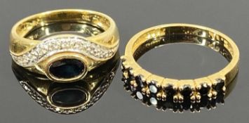 18CT GOLD DRESS RINGS (2) - the first having an inline setting of eight claw mounted black stones,