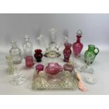 CRANBERRY GLASS DECANTER - of circular tapered form with clear glass foot and stopper, 27cms H,