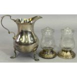 SMALL TABLE SILVER - 3 items to include a scroll handle, three footed cream jug, London 1936,