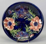 MOORECROFT 'ANEMONE' CIRCULAR SHALLOW DISH - blue ground with impressed marks, signed and with Queen