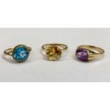 9CT GOLD SINGLE STONE SET DRESS RINGS (3) - the first with oval facet cut amethyst colour stone,