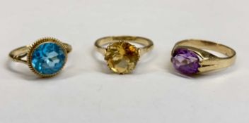 9CT GOLD SINGLE STONE SET DRESS RINGS (3) - the first with oval facet cut amethyst colour stone,