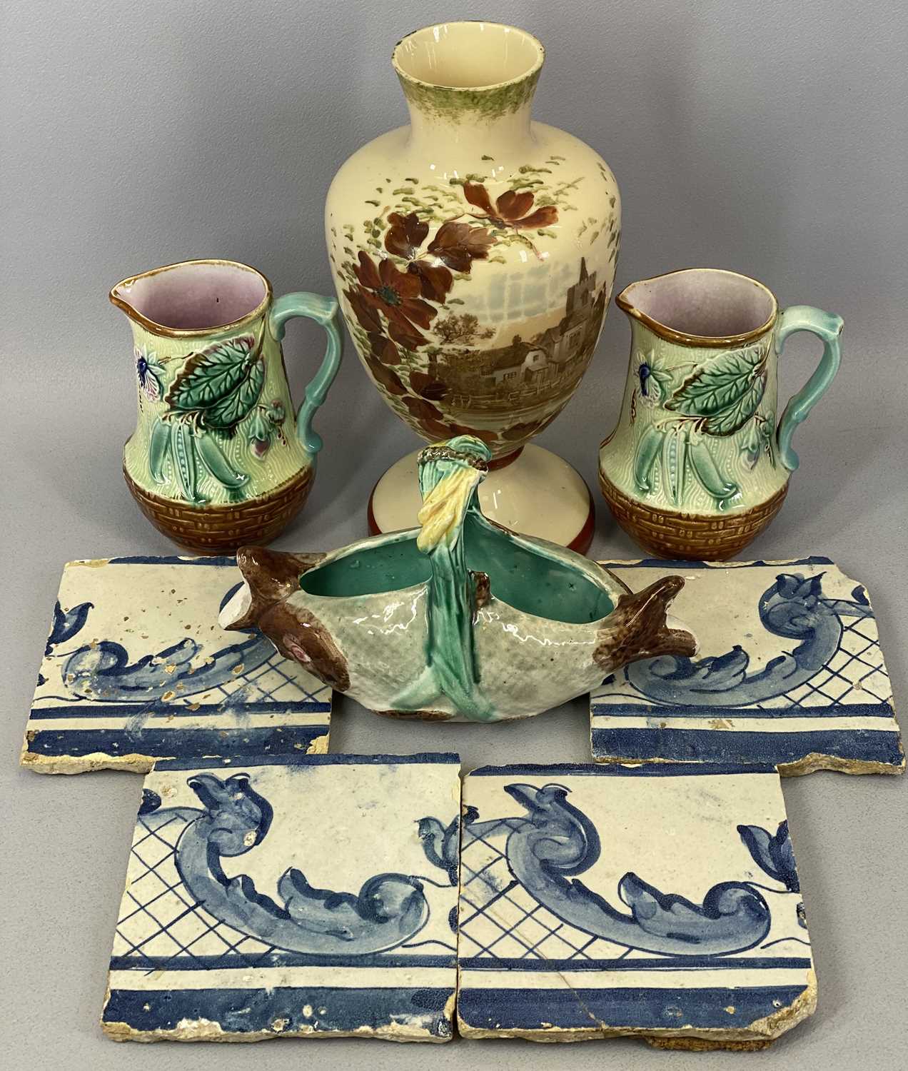 MAJOLICA JUGS, A PAIR - late 19th century, moulded with flowers, leaves and with basket weave