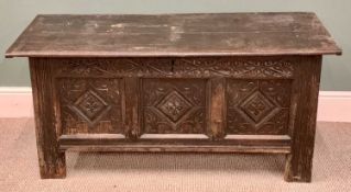 CIRCA 1800 CARVED OAK COFFER - the wide boarded lid with cleated ends over a carved frieze and three