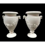 PAIR OF SWANSEA BISCUIT PORCELAIN VASES circa 1817-1820, urn form raised on a circular base, the