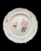 NANTGARW PORCELAIN PLATE circa 1818-1820, of lobed form, typically moulded with c-scrolls, decorated