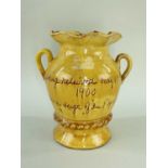 EWENNY SLIPWARE POTTERY COMMEMORATIVE VASE with twin loop handles and spreading foot, crimped rim,
