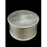 CIRCULAR SILVER TABLE BOX WITH WELCH REGIMENT RELATED ENGRAVING of plain form having feathered rims,