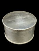 CIRCULAR SILVER TABLE BOX WITH WELCH REGIMENT RELATED ENGRAVING of plain form having feathered rims,