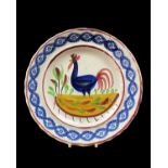 GOOD LLANELLY POTTERY COCKEREL PLATE, circa 1900, continuous sponged floral border in blue, the