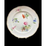 NANTGARW PORCELAIN PLATE circa 1818-1820, of lobed form, decorated with large off-centre posy and