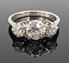 WHITE METAL THREE-STONE DIAMOND RING the three old cut stones measuring 1.3cts overall approx., ring