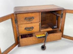 EDWARDIAN OAK SMOKER'S CABINET, moulded top and glazed doors, fitted interior with drawers and rack,