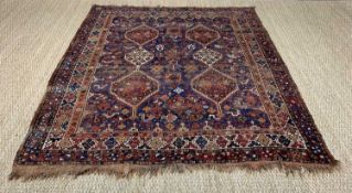 SHIRAZ RUG, orange, blue, and cream, with two geometric lozenge shaped pendant medallions, inside