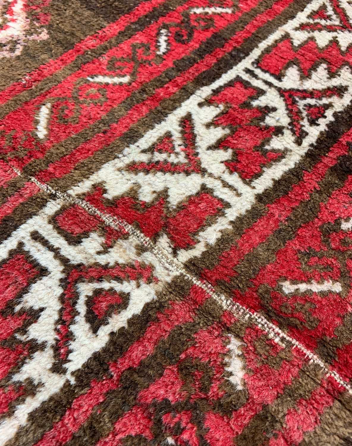 TURKISH RUG, red, white, and brown, with hooked lozenge medallion, 135 x 300cmsComments: - Image 2 of 3
