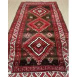 TURKISH RUG, red, white, and brown, with hooked lozenge medallion, 135 x 300cmsComments: