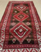 TURKISH RUG, red, white, and brown, with hooked lozenge medallion, 135 x 300cmsComments: