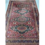 EASTERN WOOLLEN RUG - red ground with multiple zig zag pattern border and four central diamonds