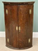 ANTIQUE OAK BOW FRONTED WALL HANGING CORNER CUPBOARD - having twin doors with four interior shelves,