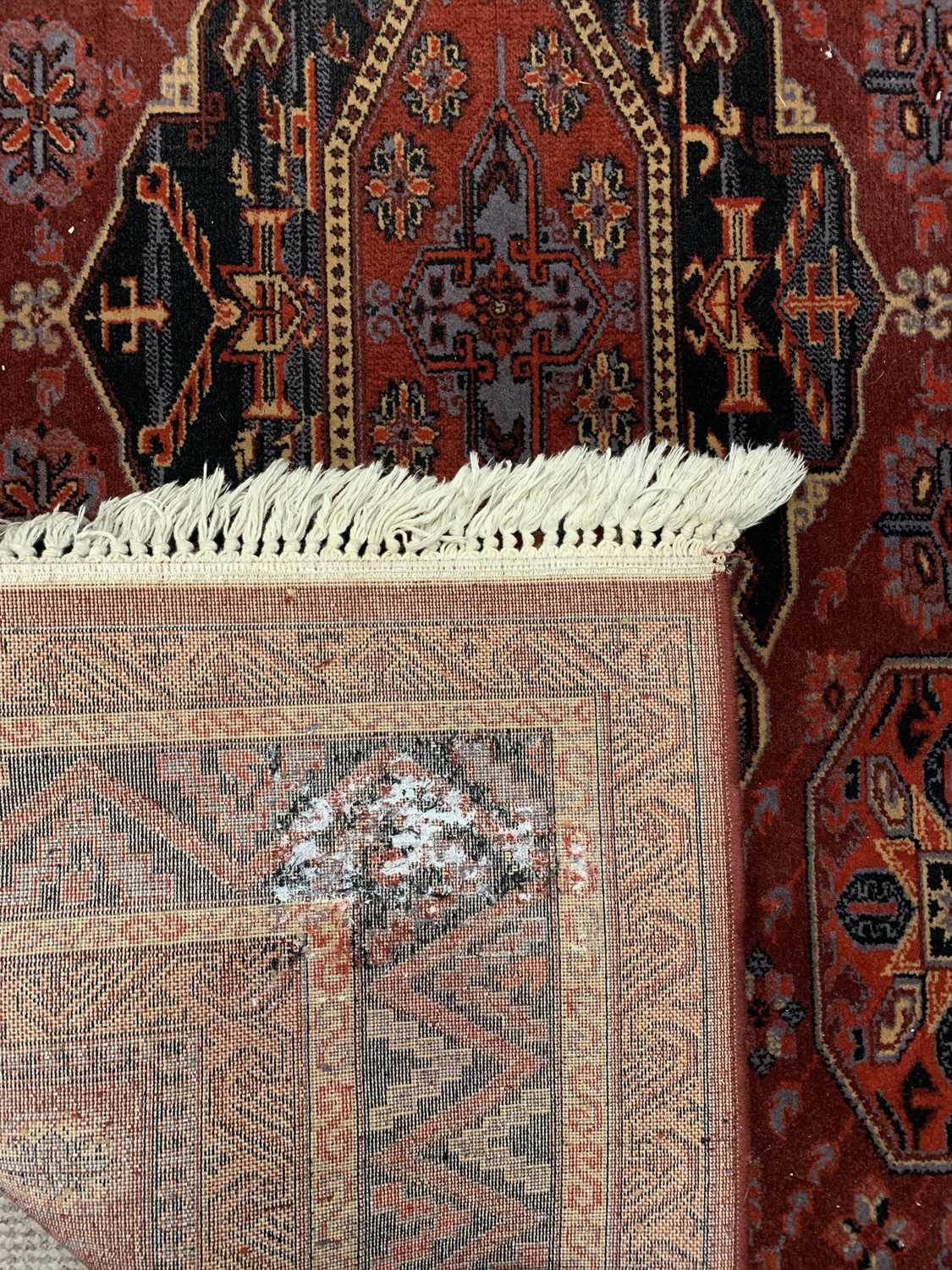 EASTERN WOOLLEN RUG - red ground with multiple zig zag pattern border and four central diamonds - Image 2 of 2