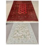 RUGS (2) - Eastern red ground with multi-pattern border and central circular motifs, 144 x 200cms