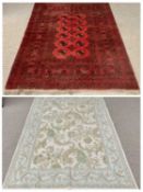 RUGS (2) - Eastern red ground with multi-pattern border and central circular motifs, 144 x 200cms