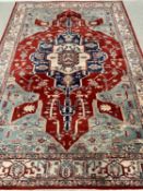 EASTERN WOOLLEN RUG - green and cream ground with red central motif, 298 x 200cms