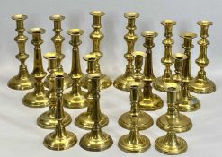 VICTORIAN BRASS CANDLESTICKS, 9 PAIRS - with circular bases and knopped columns, 26.5cms the