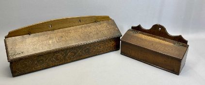 AN ANTIQUE OAK CANDLE BOX - sloping lift-up lid with moulded rim, the front carved with scrolls