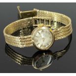 9CT GOLD LADY'S VINTAGE WRISTWATCH - with integral 9ct bracelet, the dial set with Arabic numerals