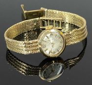 9CT GOLD LADY'S VINTAGE WRISTWATCH - with integral 9ct bracelet, the dial set with Arabic numerals