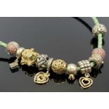 PANDORA NECKLACE with 14ct gold, silver and gold, diamond set and other beads, eleven in total on