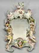 A DRESDEN PORCELAIN WALL MIRROR - early 20th century of Rococo form with floral encrusted and