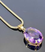 9CT GOLD MOUNTED LARGE FACET CUT AMETHYST PENDANT on a 9ct gold snake link necklace, 33 x 25mm