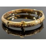 VICTORIAN 9CT GOLD HOLLOW CORE BANGLE - with safety chain, chase decorated leaves within a belt