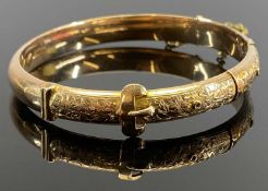 VICTORIAN 9CT GOLD HOLLOW CORE BANGLE - with safety chain, chase decorated leaves within a belt