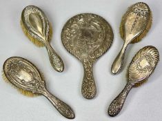 SILVER DRESSING TABLE HAND MIRROR & BRUSHES GROUP - 5 items, all having embossed floral scrolls or