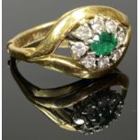 18CT GOLD & PLATINUM EMERALD & DIAMOND RING - having an openwork crest mount set with an oval