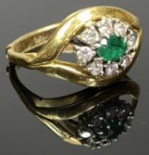 18CT GOLD & PLATINUM EMERALD & DIAMOND RING - having an openwork crest mount set with an oval