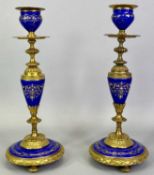 FINE QUALITY CONTINENTAL PORCELAIN & GILT ORMOLU CANDLESTICKS, A PAIR, - the blue porcelain sections