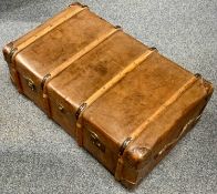 A LEATHER STEAMER TRUNK – early 20th century clad with bentwood bands, brass locks and clasps with