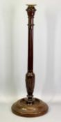 A TALL TURNED MAHOGANY CANDLESTICK - early 19th century, the column fluted and carved with