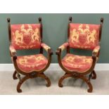 REGAL TYPE ARMCHAIRS - a pair, having "X" framed and arched stretchers, with ornate carvings and