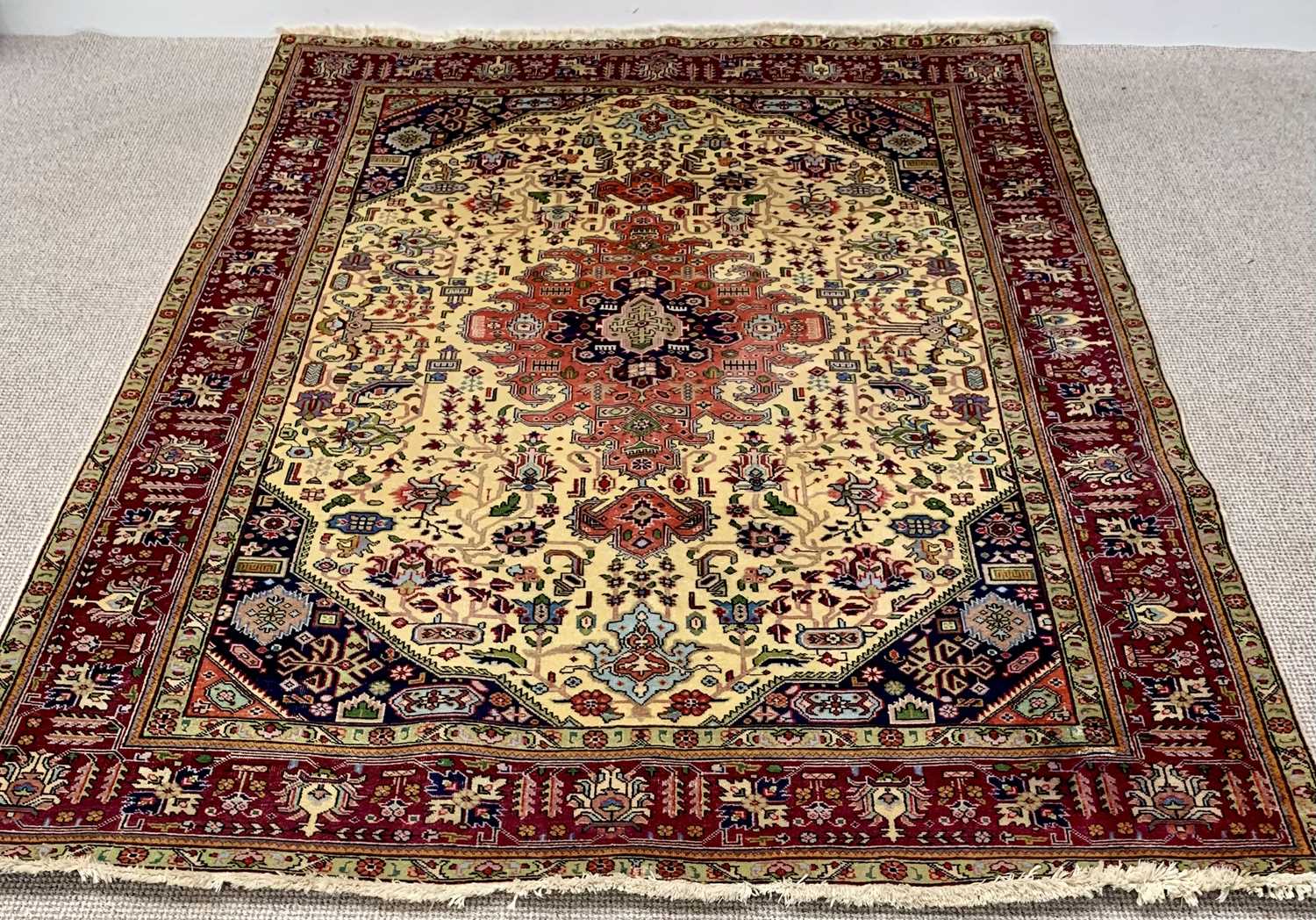 LARGE EASTERN STYLE RUG - multiple bordered with tasselled ends, traditional central motif and